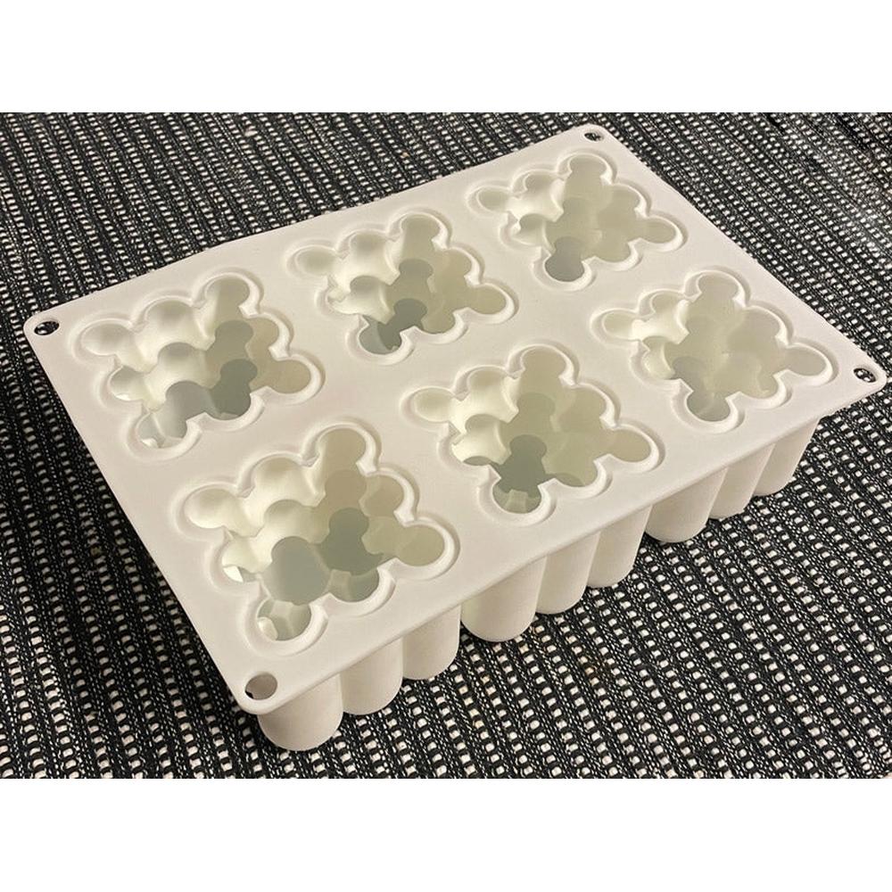 Hvit silikon støpeform for 6 boblelys, hver med 3x3x3 bobler, på et mørkt teksturert underlag.