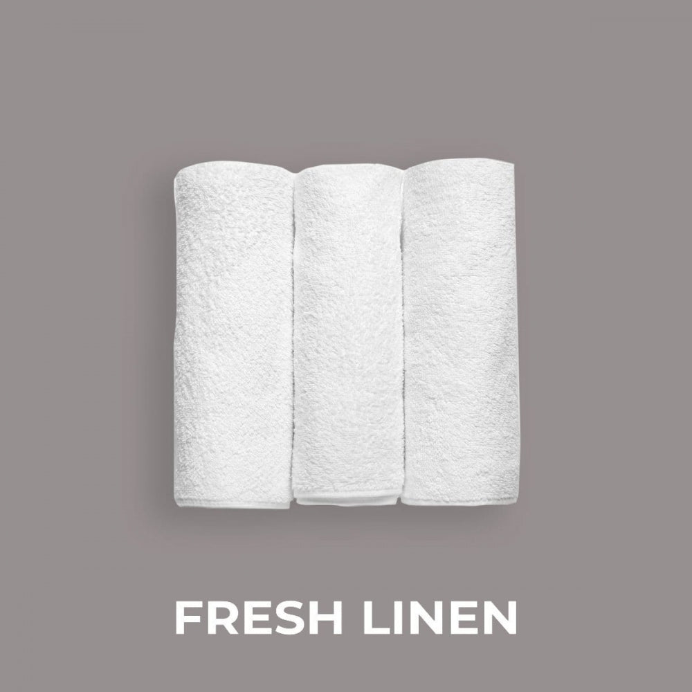Tre hvite, sammenrullede håndklær på grå bakgrunn, merket "Fresh Linen